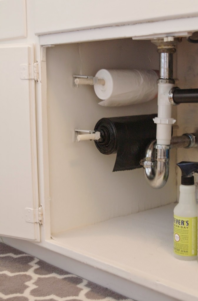 Hang trash bags on a roll under the sink