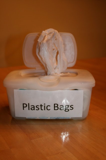 Repurpose an old baby wipe container into storage for plastic bags