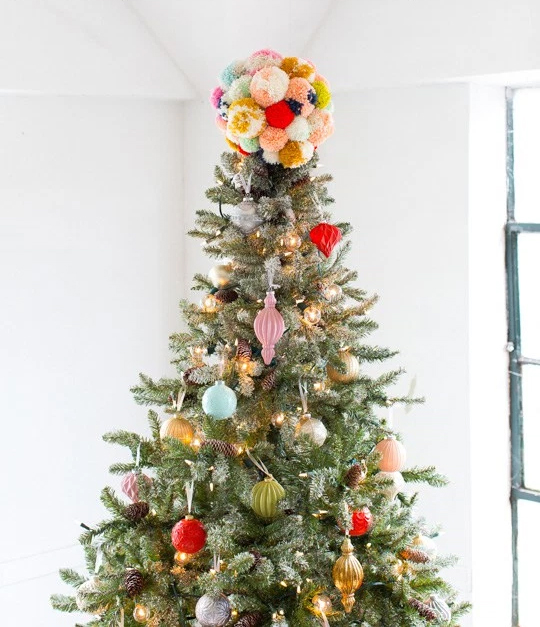 Add a touch of color to your Christmas tree with this DIY pom pom tree topper