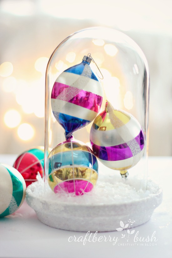 Christmas cloche made from an old clock dome and a spray-painted terra cotta dish covered in glitter