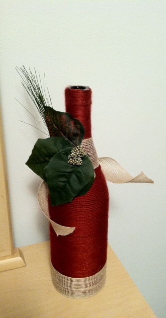 Red yarn wrapped wine bottle