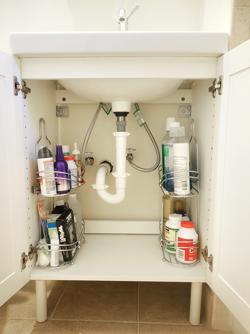 Use shower caddies as shelving to organize awkward sink spaces