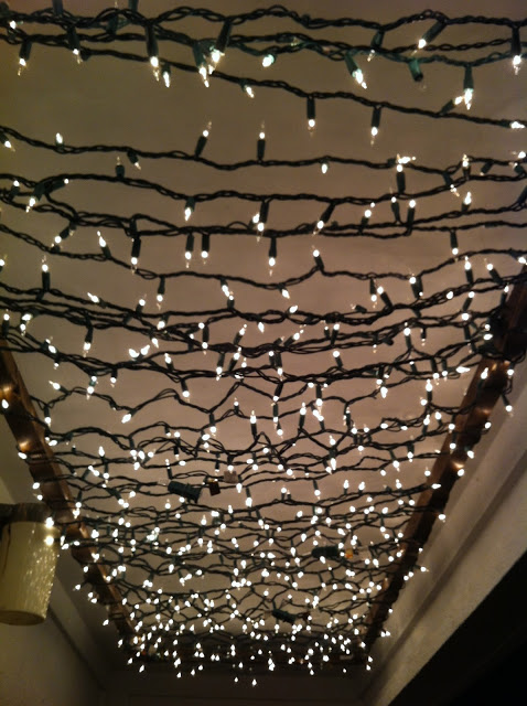Using Christmas lights create a twinkle light porch canopy
