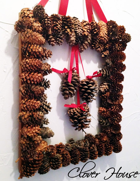 Create a wreath using picture frame and pine cones