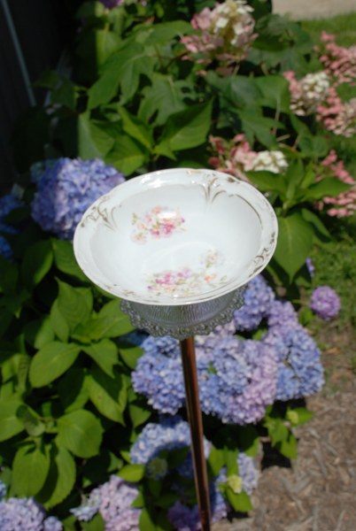 Make a little bird bath out of old china and glass