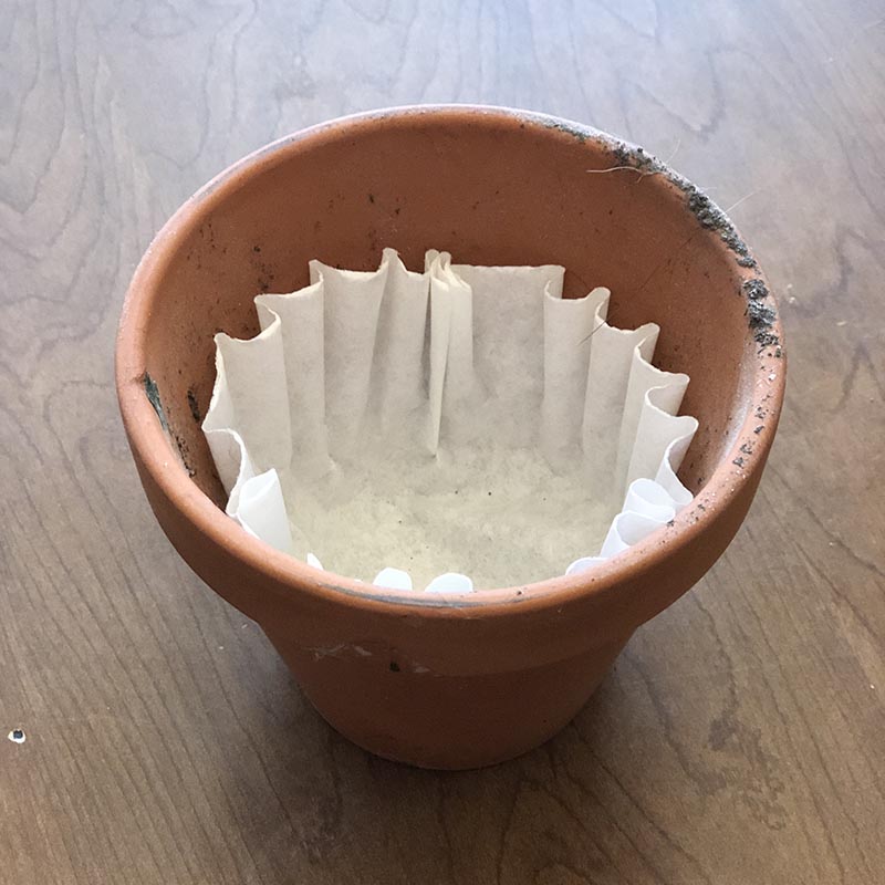 Line your pots with coffee filters